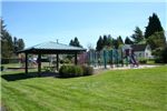 Shelterhouse, Playground, and Open Grassy Area at Bailey Park on a Clear Day